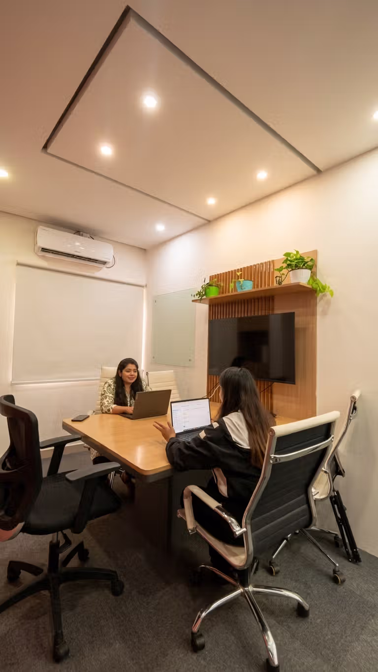 Two employees are discussing in premium private cabin in coworking office space in Indiranagar